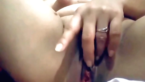 Cute asian girl is fingering her pussy in the web camera