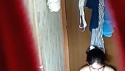 Indian brunette is in the shower and she is dressed in her bikini