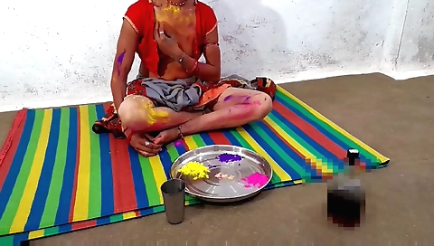 Indian man is shaving his friend's head and shoving it