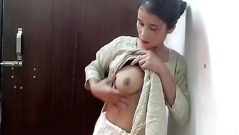 Indian woman in a sexy dress is getting naked in her bedroom