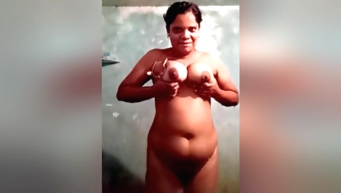 Busty brunette takes off sexy outfit in the shower
