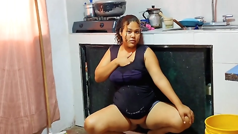 Homemade brunette stepdaughter cleaning the kitchen